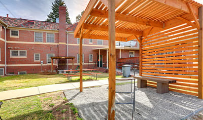 Outdoor sitting area with pergola and benches