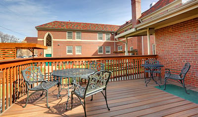 Outdoor seating area with tables on a wooden deck