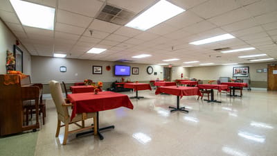 Interior dining area with tables set for residents