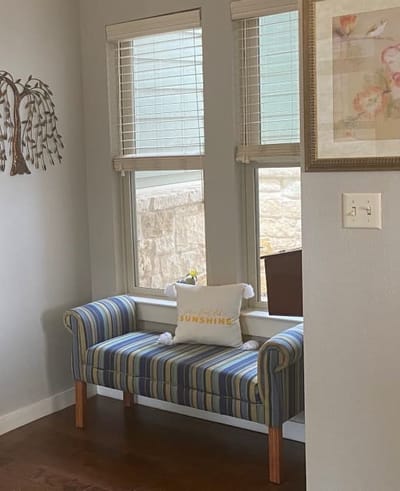 Cozy sitting area with a striped bench and decoration