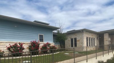 Exterior view of a senior living facility with landscaping