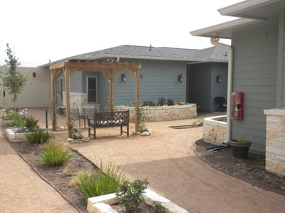 Outdoor patio area with seating and garden features