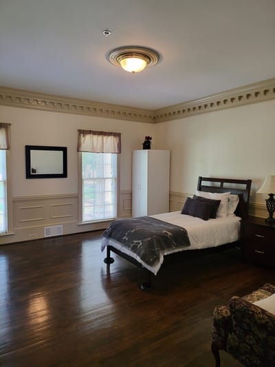 Cozy private resident room with a bed and furniture
