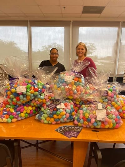 Staff members with colorful Easter eggs for an event