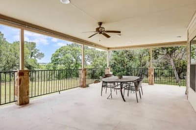 Covered outdoor space with seating and greenery