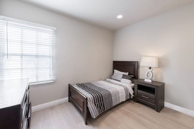 Private bedroom with a bed and lamp