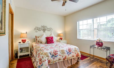 Well-decorated private resident room with floral bedding