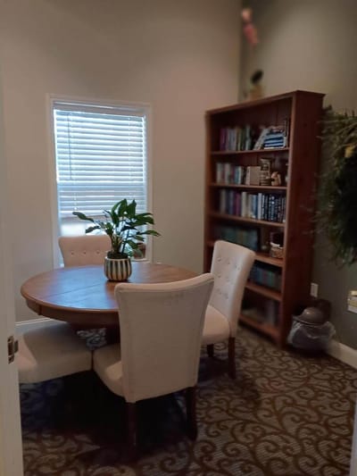 Small interior room with a round table and bookshelves