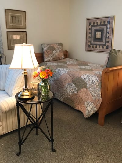Cozy interior of a resident's room with decorative quilt