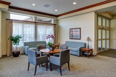Bright common area with seating and a plant