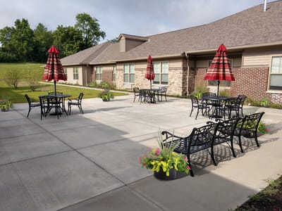 Outdoor seating area with umbrellas and flower pots