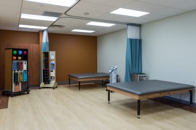 Interior view of a rehabilitation therapy room with equipment
