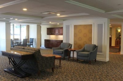 Common area with seating and decor in a senior living facility