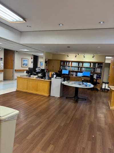 Interior view of a reception area with desks and filing cabinets