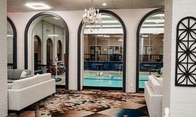 Interior view of a lounge area overlooking a pool