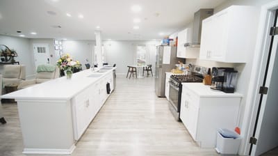 Bright interior common area with kitchen and seating