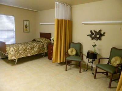 Interior of a resident room with bed and chairs