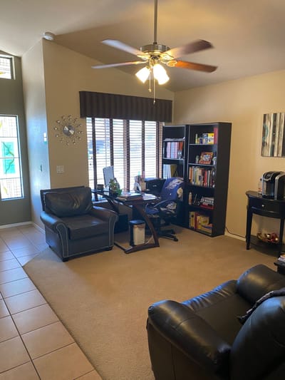 Interior view of a common area with seating and bookshelves.