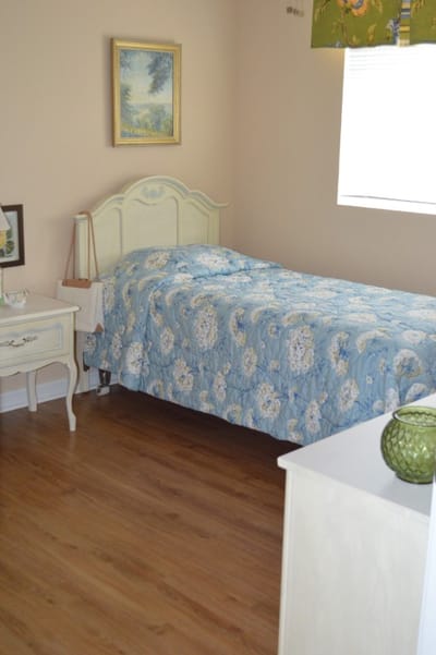 Cozy resident room with a bed and artwork