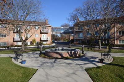 Outdoor seating area with fountain and landscaping
