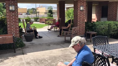 Residents enjoying the shaded outdoor seating area