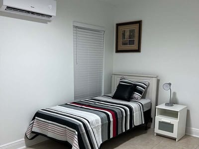 Private resident room with a bed and bedside table