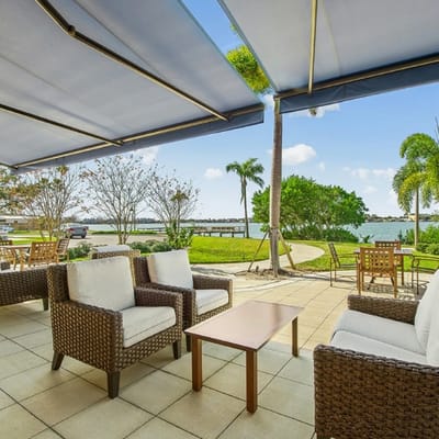 Outdoor seating area overlooking a garden and water