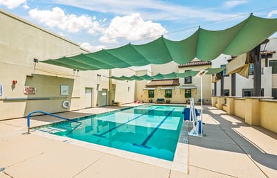 Outdoor pool area with shaded seating