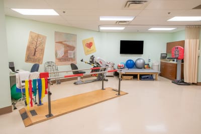 Physical therapy area with exercise equipment and motivational art