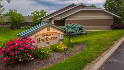 Exterior view of The Home at Hearthstone with colorful flowers