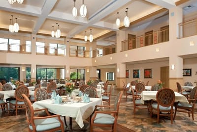 Bright dining room with tables set for residents