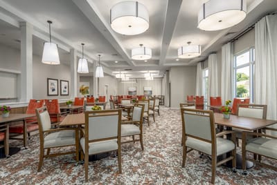 Bright and spacious dining room with tables and chairs
