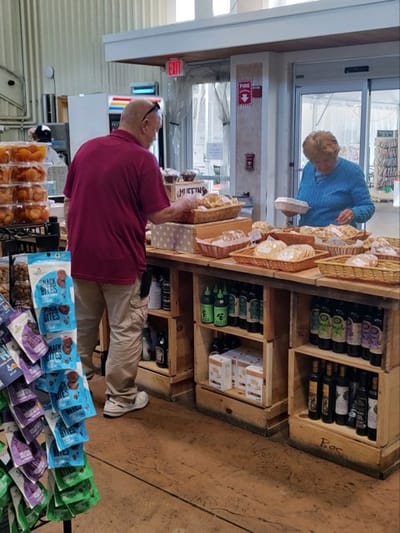 Staff assisting resident in a food service area