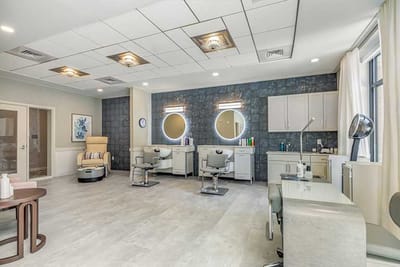 Bright beauty salon area with hair styling stations