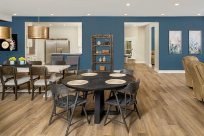 Bright dining area with a large circular table and chairs