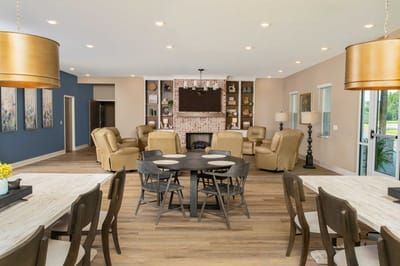 Bright common area with comfortable seating and dining tables
