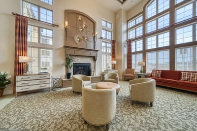 Bright common area with large windows and comfortable seating