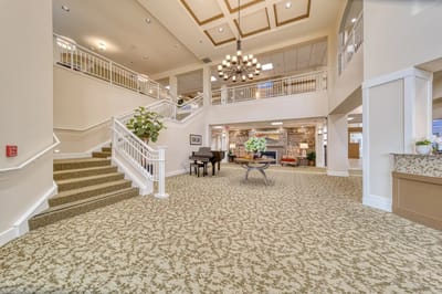 Spacious lobby area with staircase and seating