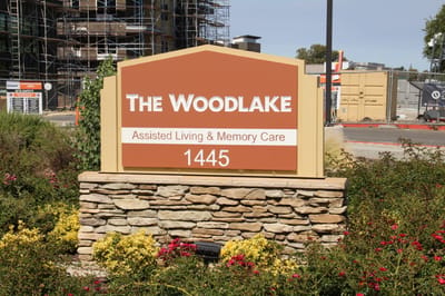 Sign for The Woodlake Senior Living facility