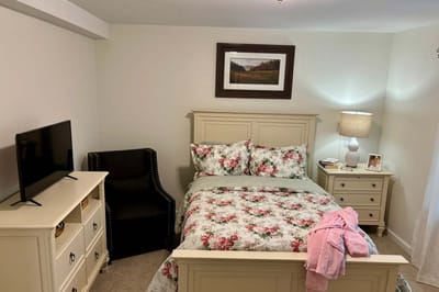 Cozy private resident room with floral bedding and decor