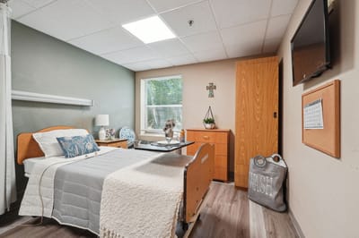 A cozy resident room with a bed and personal items