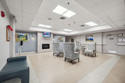 A view of a cozy common area with seating and artwork