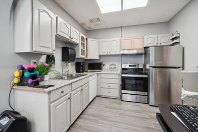 Modern kitchen area with appliances and storage
