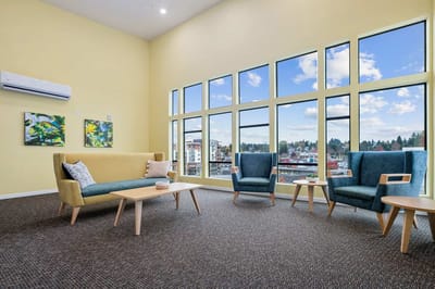 Bright common area with large windows and comfortable seating