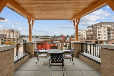 Outdoor patio area with seating and gardens