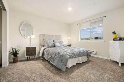 Brightly decorated private resident room with a bed and window