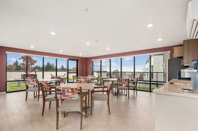 Bright dining area with large windows and seating