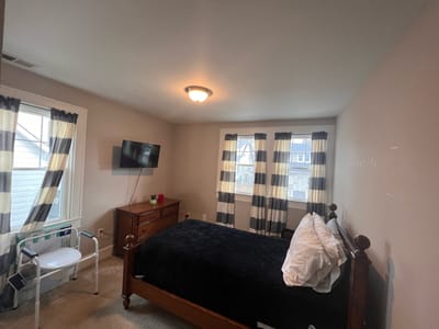 A private resident room with a bed and TV