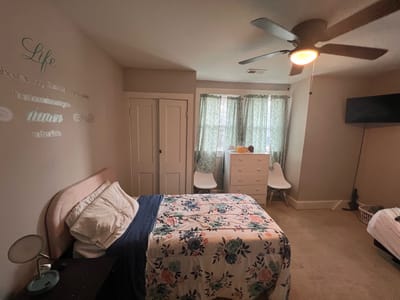 Cozy resident room with floral bedding and natural light
