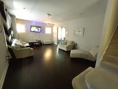 Bright living room area with seating and TV